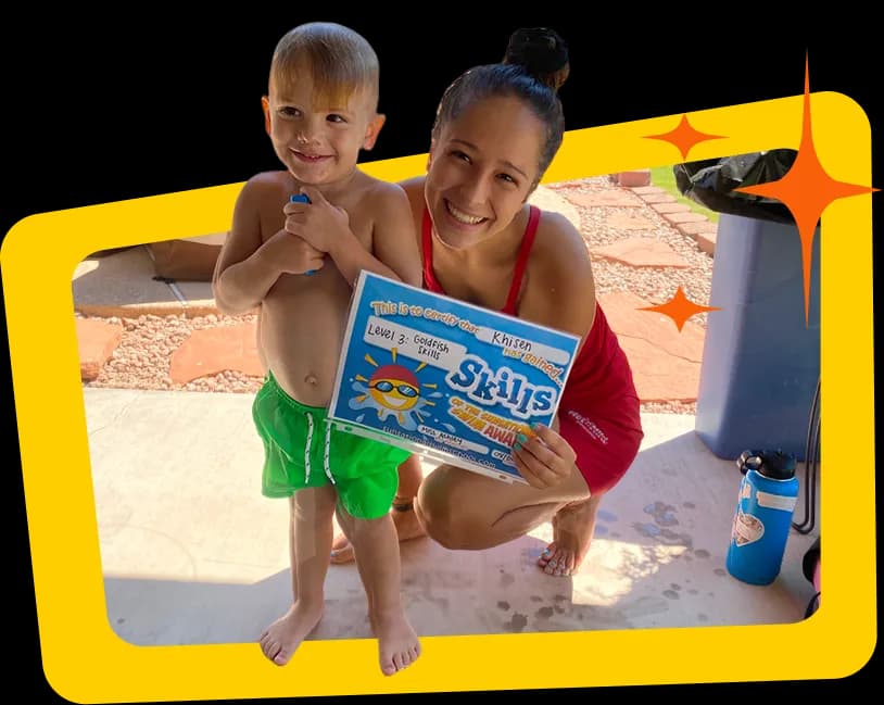 Instructor and child holding skill certificates by the pool
